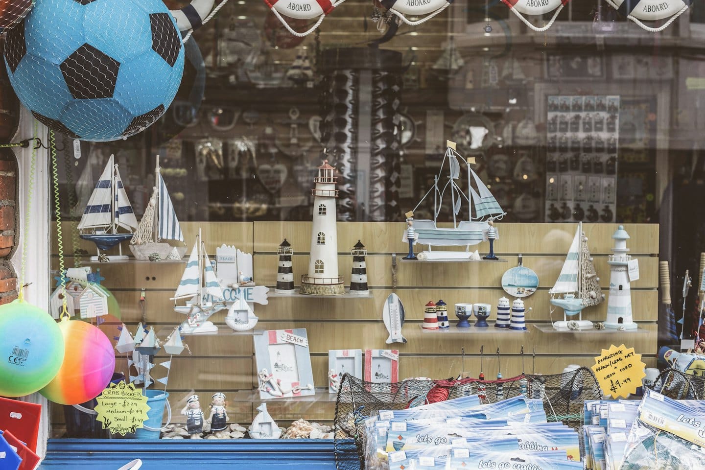 Nautical souvenirs and beach accessories displayed in a shop window.